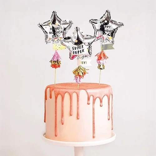  celebratory cake, pink drip cake, metallic star toppers, birthday cake, fondant cake